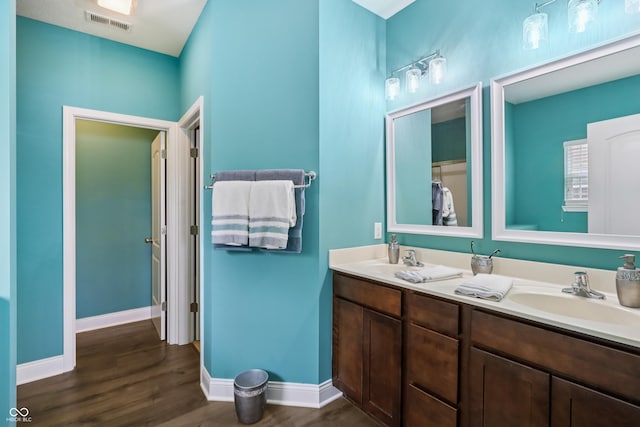 1893 Devonshire Ave, Avon, IN 46123 - bathroom with wood finished floors, double vanity, and baseboards
