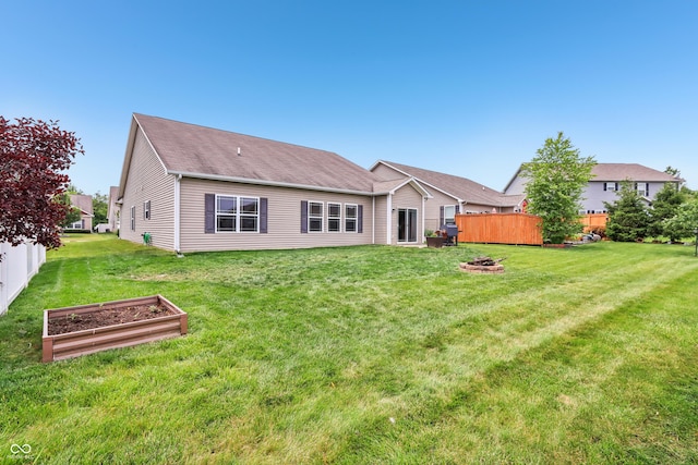 1893 Devonshire Ave, Avon, IN 46123 - back of house with an outdoor fire pit, a vegetable garden, and a shingled roof