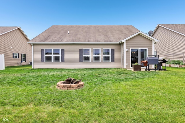 1893 Devonshire Ave, Avon, IN 46123 - back of property featuring a fire pit, a lawn, and a shingled roof