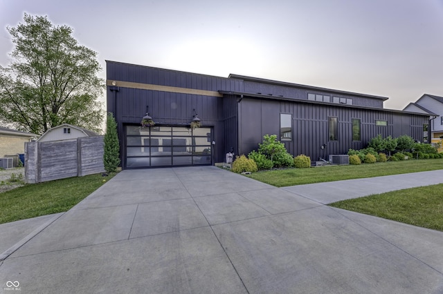 8695 Morgan Dr, Fishers, IN 46038 - contemporary house featuring a garage, concrete driveway, and board and batten siding