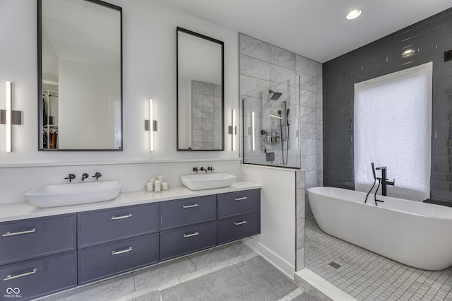 8695 Morgan Dr, Fishers, IN 46038 - bathroom featuring double vanity, a walk in shower, a soaking tub, recessed lighting, and tile patterned flooring