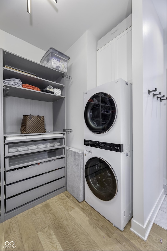 8695 Morgan Dr, Fishers, IN 46038 - washroom featuring estacked washer and dryer and light wood-style flooring