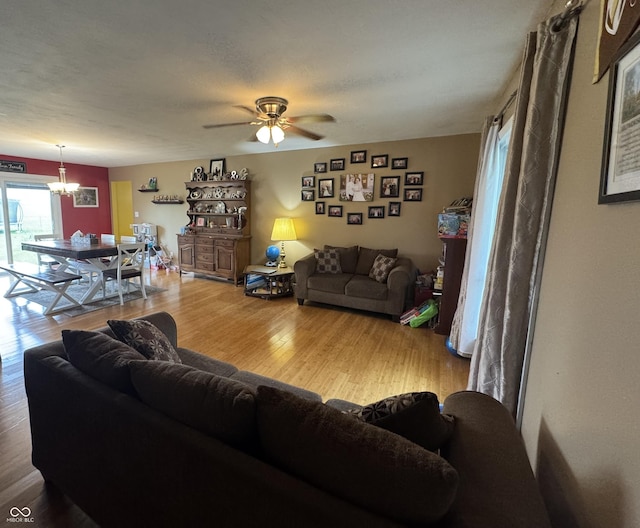 800 N Walnut Hls, Crawfordsville, IN 47933 - living area featuring wood finished floors, a ceiling fan, and a chandelier