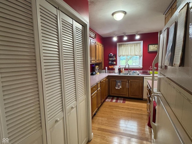 800 N Walnut Hls, Crawfordsville, IN 47933 - kitchen with a sink, light wood finished floors, light countertops, brown cabinets, and track lighting