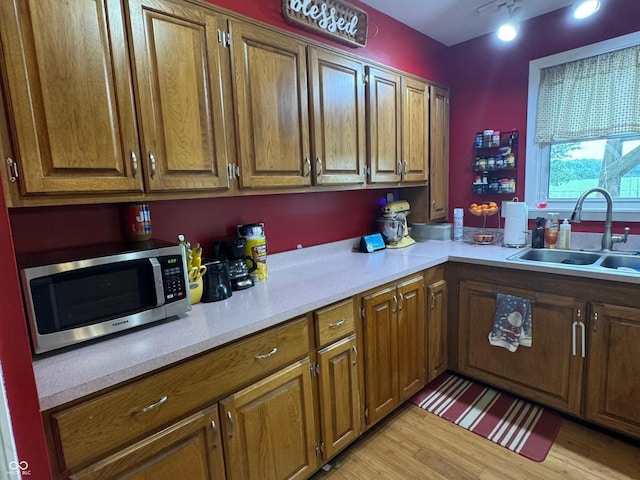 800 N Walnut Hls, Crawfordsville, IN 47933 - kitchen with stainless steel microwave, a sink, light countertops, and brown cabinets