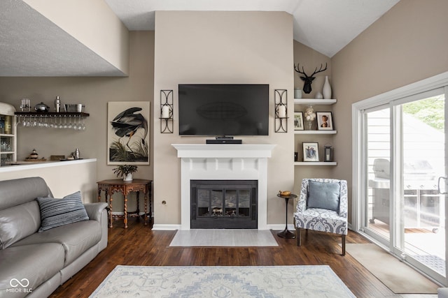 8133 Lower Bay Ln, Indianapolis, IN 46236 - living area featuring wood finished floors, vaulted ceiling, and a fireplace with flush hearth