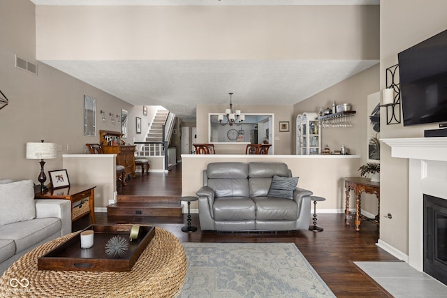 8133 Lower Bay Ln, Indianapolis, IN 46236 - living area with stairs, wood finished floors, a fireplace with flush hearth, and a chandelier