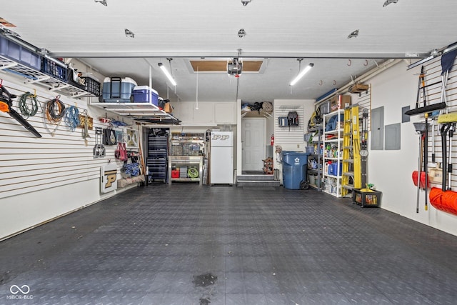 8133 Lower Bay Ln, Indianapolis, IN 46236 - garage with freestanding refrigerator, a garage door opener, and electric panel