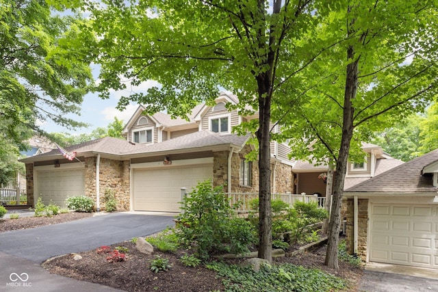 8133 Lower Bay Ln, Indianapolis, IN 46236 - traditional home featuring stone siding, roof with shingles, asphalt driveway, and a garage