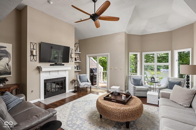 8133 Lower Bay Ln, Indianapolis, IN 46236 - living area with a ceiling fan, a glass covered fireplace, high vaulted ceiling, wood finished floors, and a textured ceiling