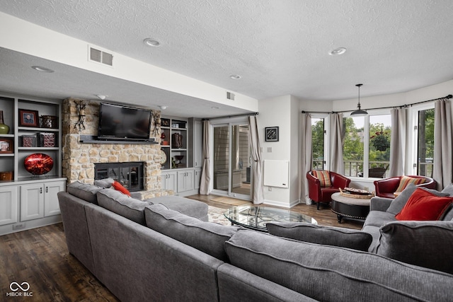 8133 Lower Bay Ln, Indianapolis, IN 46236 - living room with a textured ceiling, dark wood-type flooring, a fireplace, plenty of natural light, and built in features