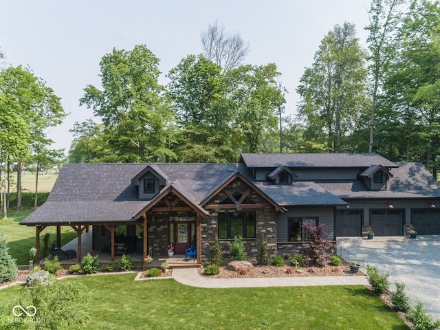 2004 Layton Rd, Anderson, IN 46011 - view of front of home with a porch, a front yard, stone siding, driveway, and a shingled roof