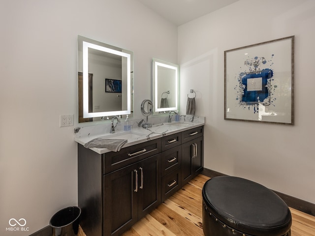 2004 Layton Rd, Anderson, IN 46011 - full bathroom featuring wood finished floors, double vanity, and baseboards