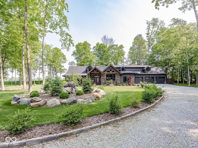 2004 Layton Rd, Anderson, IN 46011 - view of front of house with stone siding, gravel driveway, a front lawn, and an attached garage