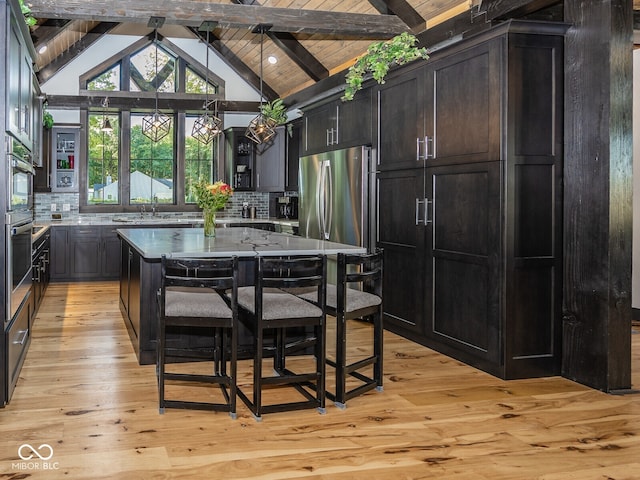2004 Layton Rd, Anderson, IN 46011 - kitchen with appliances with stainless steel finishes, decorative backsplash, light wood-style flooring, a sink, and decorative light fixtures