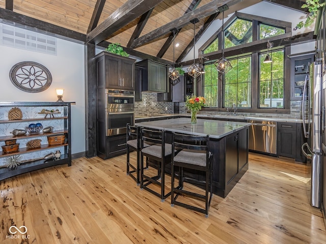 2004 Layton Rd, Anderson, IN 46011 - kitchen featuring stainless steel appliances, backsplash, light wood-style floors, a center island, and a sink