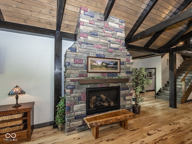 2004 Layton Rd, Anderson, IN 46011 - living area featuring stairway, baseboards, wood finished floors, a stone fireplace, and wood ceiling