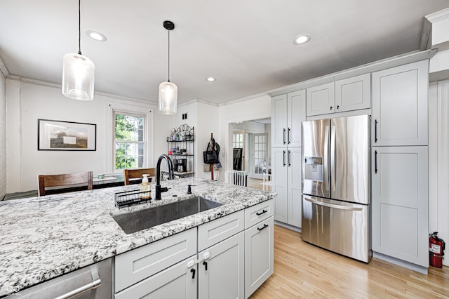 8436 E 56th St, Indianapolis, IN 46216 - kitchen featuring stainless steel appliances, light stone counters, hanging light fixtures, light wood-style flooring, and recessed lighting