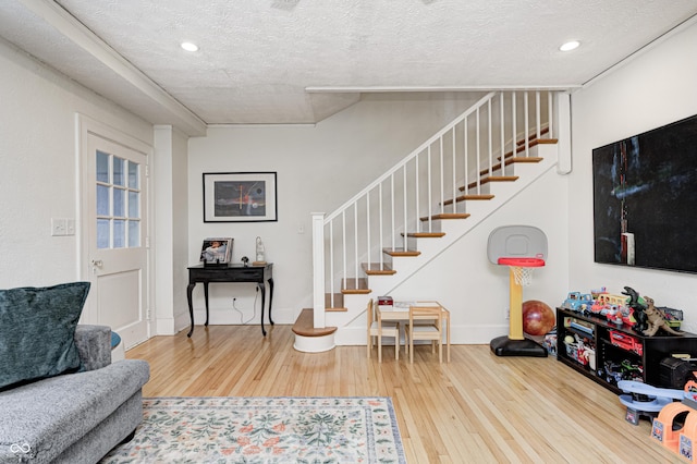 8436 E 56th St, Indianapolis, IN 46216 - living room with stairway, wood-type flooring, a textured ceiling, and recessed lighting