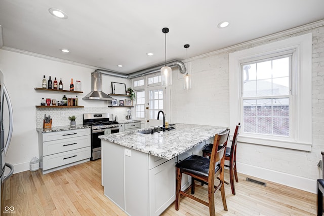 8436 E 56th St, Indianapolis, IN 46216 - kitchen with wall chimney exhaust hood, open shelves, gas range, a kitchen breakfast bar, and a peninsula