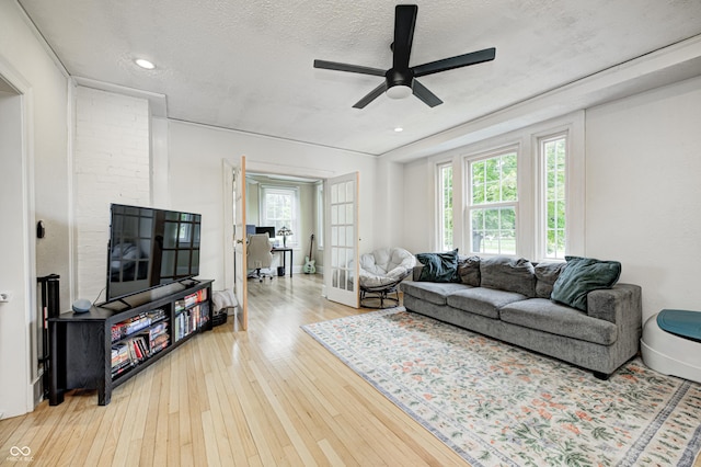 8436 E 56th St, Indianapolis, IN 46216 - living room with healthy amount of natural light, a ceiling fan, hardwood / wood-style flooring, a textured ceiling, and recessed lighting