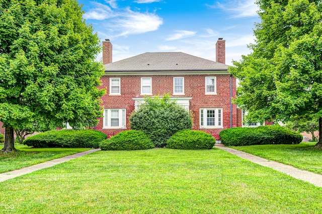 8436 E 56th St, Indianapolis, IN 46216 - colonial home with a chimney, a front lawn, and brick siding