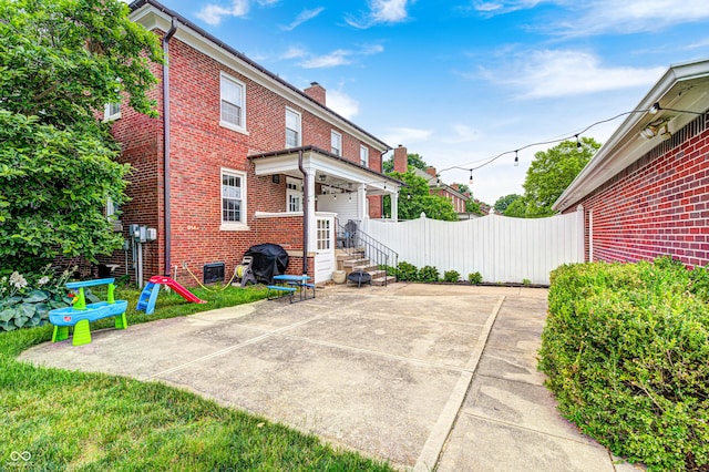 8436 E 56th St, Indianapolis, IN 46216 - rear view of property featuring brick siding, a chimney, and a patio area