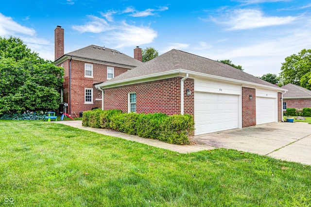 8436 E 56th St, Indianapolis, IN 46216 - view of home's exterior with brick siding, a lawn, a chimney, driveway, and an attached garage