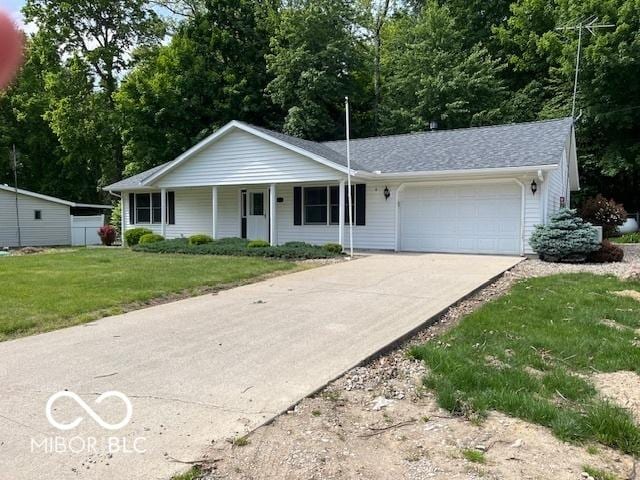 9451 S Amanda Dr, Claypool, IN 46510 - single story home with an attached garage, concrete driveway, a front yard, and a porch