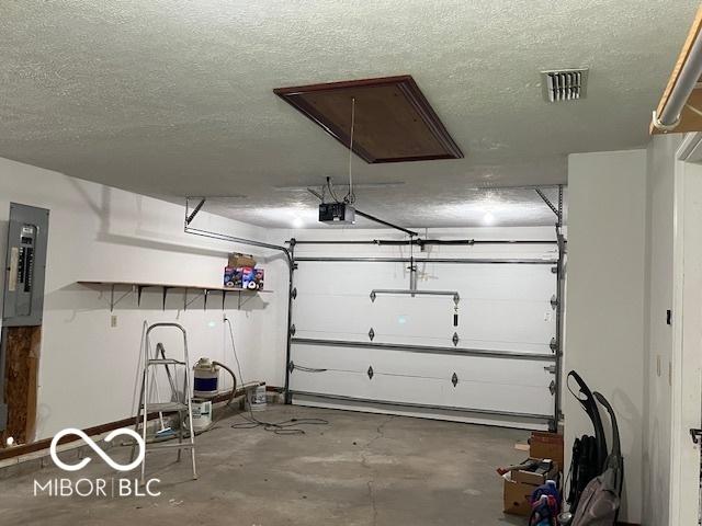 9451 S Amanda Dr, Claypool, IN 46510 - garage featuring electric panel and a garage door opener