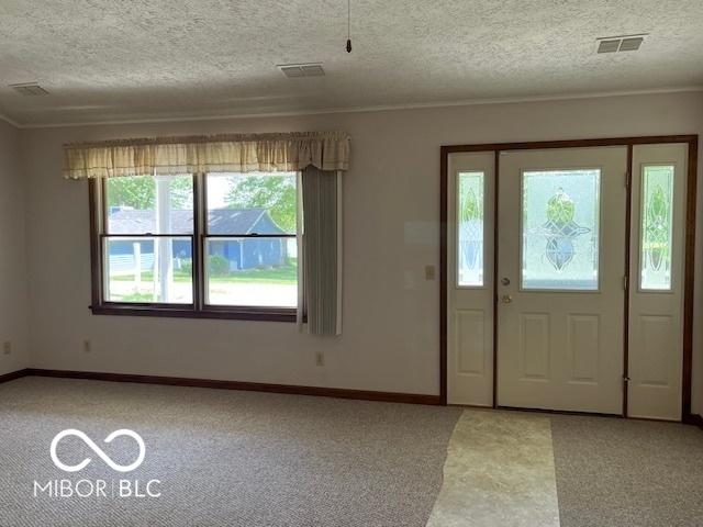 9451 S Amanda Dr, Claypool, IN 46510 - entrance foyer featuring light colored carpet, crown molding, baseboards, and a textured ceiling