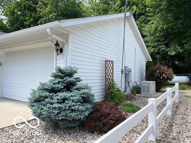 9451 S Amanda Dr, Claypool, IN 46510 - view of property exterior featuring a garage and central AC