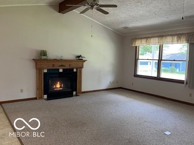 9451 S Amanda Dr, Claypool, IN 46510 - unfurnished living room featuring carpet floors, a ceiling fan, a fireplace with flush hearth, crown molding, and baseboards