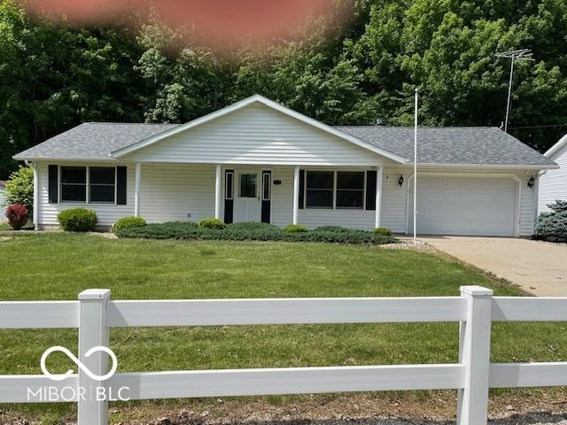 9451 S Amanda Dr, Claypool, IN 46510 - single story home with a garage, concrete driveway, covered porch, and roof with shingles