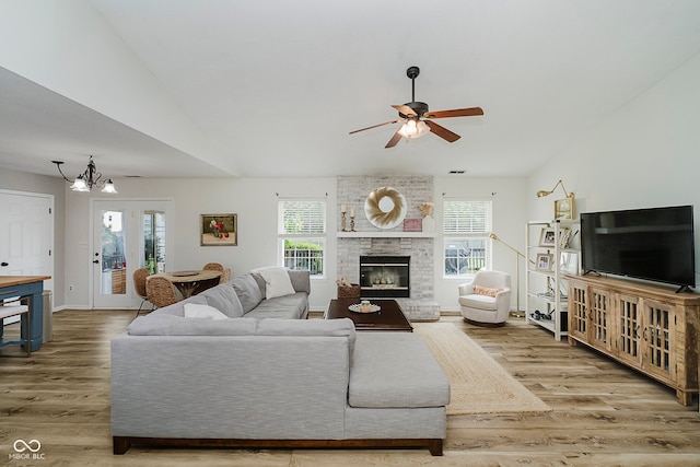 293 E Quail Wood Ln, Westfield, IN 46074 - living area featuring wood finished floors, a ceiling fan, a chandelier, a brick fireplace, and vaulted ceiling