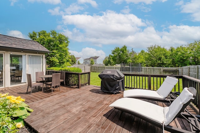 293 E Quail Wood Ln, Westfield, IN 46074 - wooden terrace with outdoor dining area, area for grilling, a fenced backyard, and a trampoline