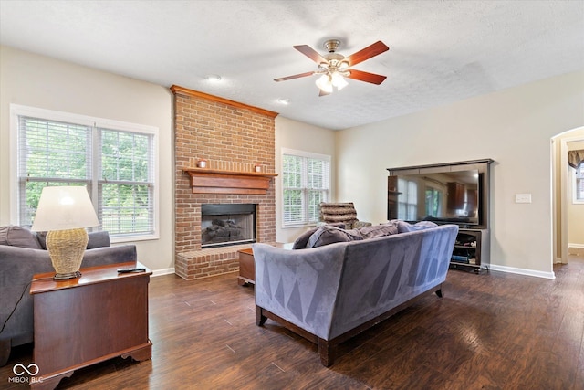 15515 Alameda Pl, Westfield, IN 46074 - living room with a ceiling fan, dark wood finished floors, baseboards, a textured ceiling, and a fireplace