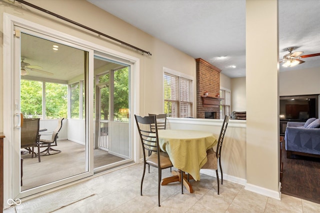 15515 Alameda Pl, Westfield, IN 46074 - tiled dining space featuring ceiling fan, a fireplace, and baseboards