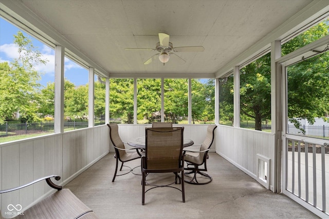 15515 Alameda Pl, Westfield, IN 46074 - sunroom / solarium featuring a ceiling fan, outdoor dining space, and view of wooded area
