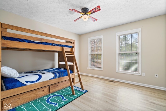 15515 Alameda Pl, Westfield, IN 46074 - bedroom featuring wood finished floors, baseboards, a textured ceiling, and ceiling fan