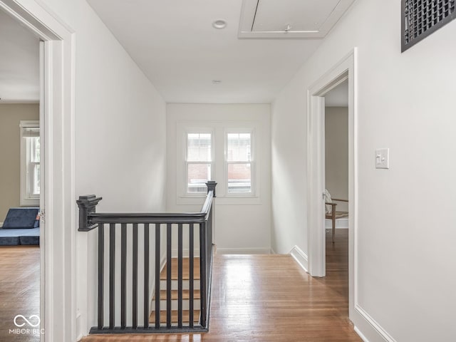 4455 Central Ave, Indianapolis, IN 46205 - hallway featuring an upstairs landing, attic access, wood finished floors, and baseboards