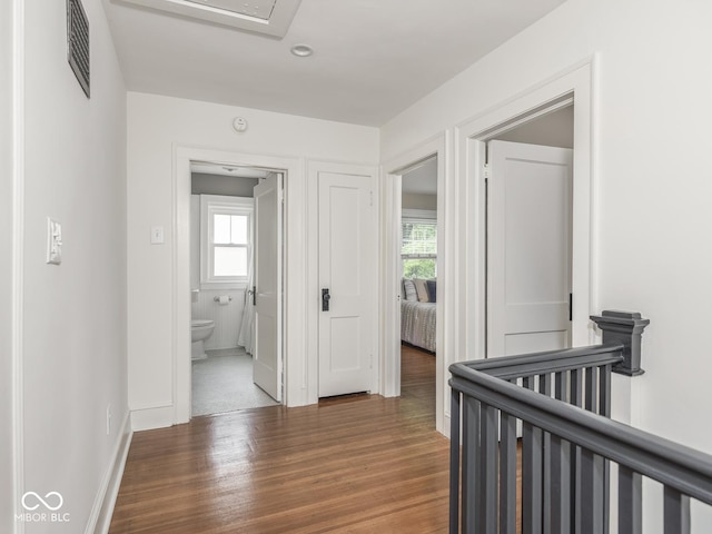 4455 Central Ave, Indianapolis, IN 46205 - hallway with healthy amount of natural light, an upstairs landing, wood finished floors, and baseboards