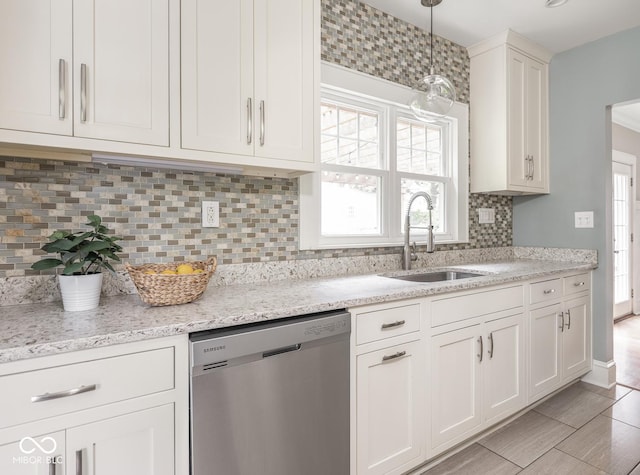 4455 Central Ave, Indianapolis, IN 46205 - kitchen with stainless steel dishwasher, a sink, white cabinetry, backsplash, and pendant lighting