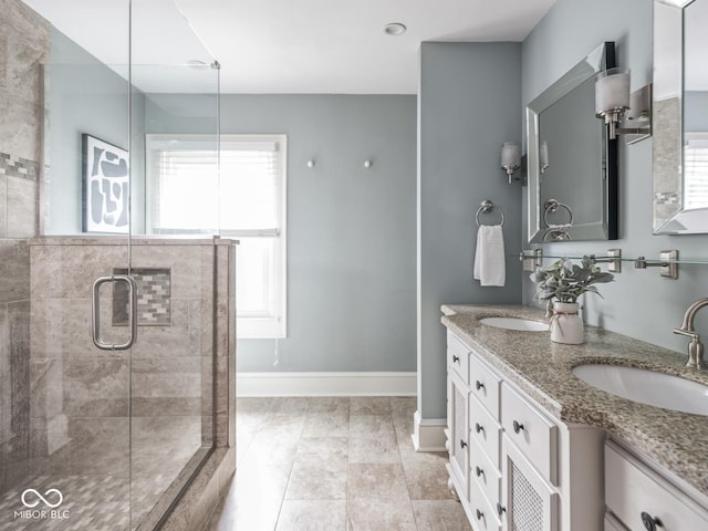 4455 Central Ave, Indianapolis, IN 46205 - bathroom featuring a stall shower, double vanity, and baseboards