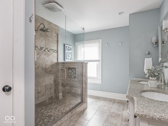 4455 Central Ave, Indianapolis, IN 46205 - bathroom with a stall shower, double vanity, baseboards, and tile patterned flooring