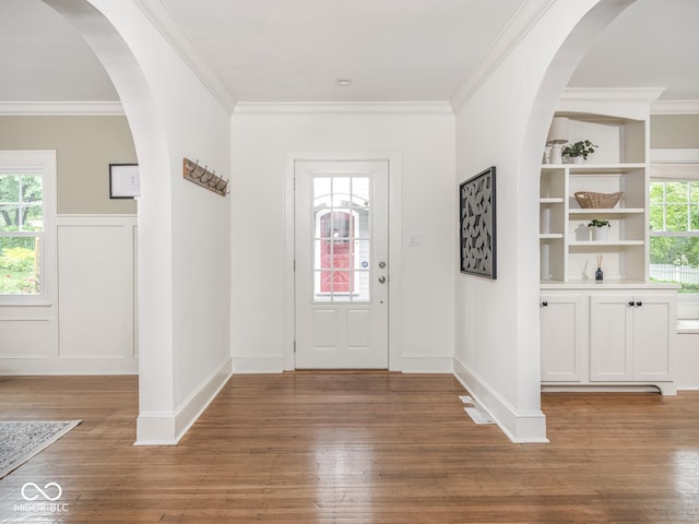 4455 Central Ave, Indianapolis, IN 46205 - entryway featuring light wood-style floors, crown molding, and wainscoting