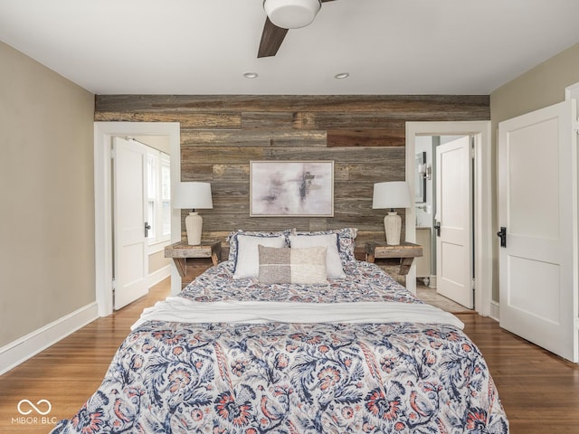 4455 Central Ave, Indianapolis, IN 46205 - bedroom with wood finished floors, baseboards, an accent wall, wooden walls, and recessed lighting