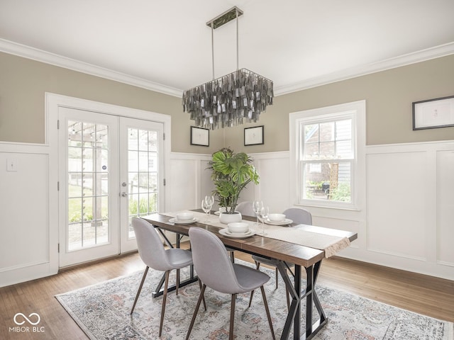 4455 Central Ave, Indianapolis, IN 46205 - dining area with a decorative wall, ornamental molding, french doors, a wainscoted wall, and light wood-style floors