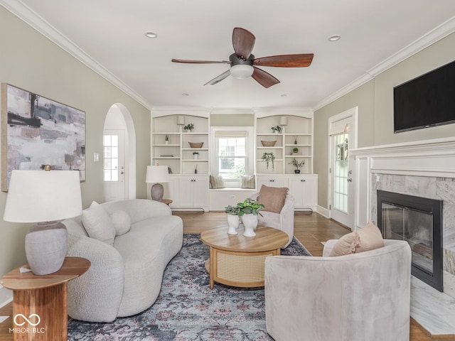 4455 Central Ave, Indianapolis, IN 46205 - living area featuring ceiling fan, a fireplace, arched walkways, ornamental molding, and wood finished floors