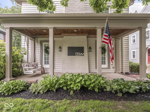 4455 Central Ave, Indianapolis, IN 46205 - property entrance featuring covered porch and brick siding